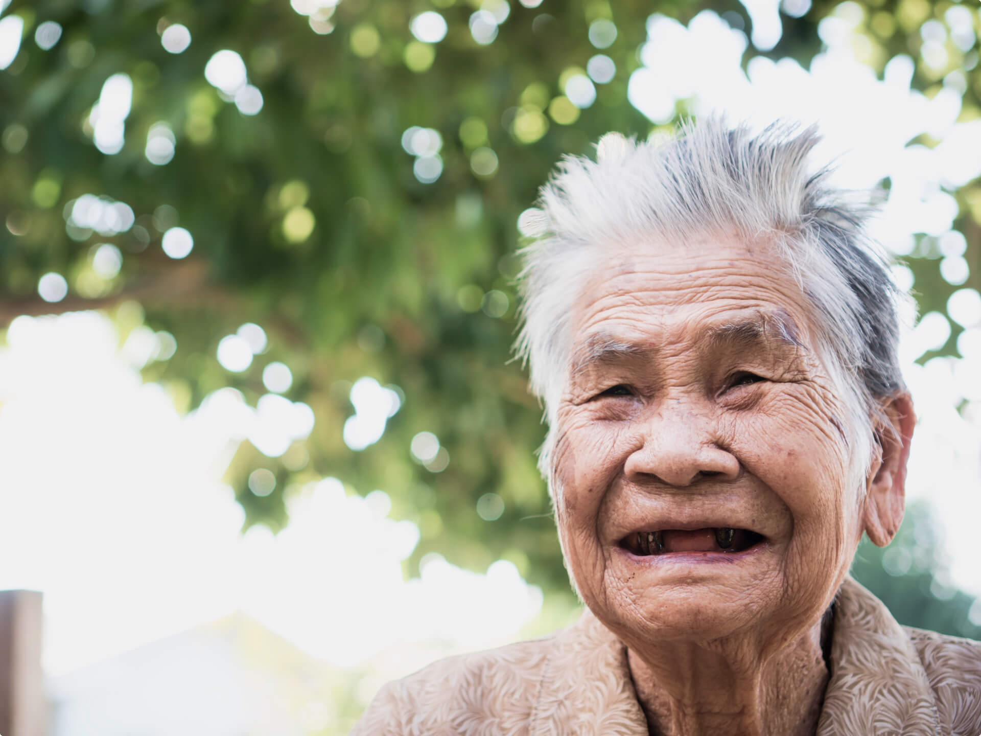 Memory care resident smiling outdoors