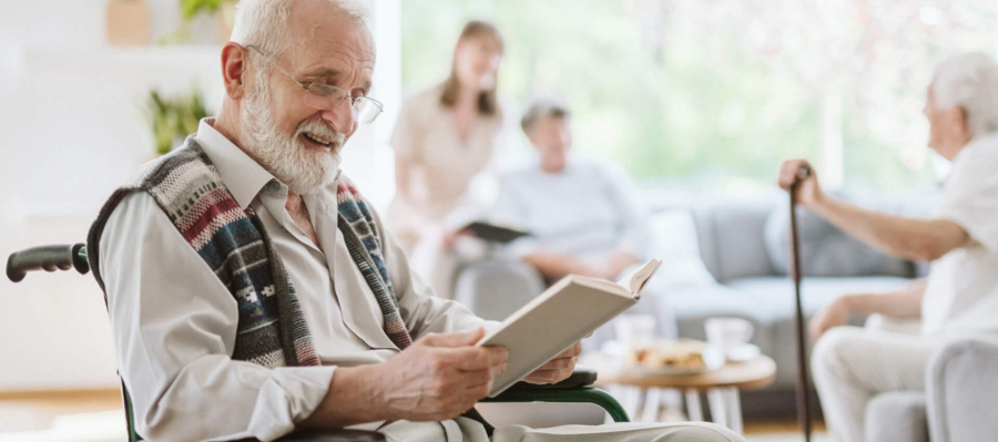 Senior Reading in his wheelchair