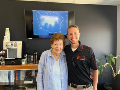 Evelyn Kidd poses with a team member from Elite Aviation before taking her flight over the Mississippi River.