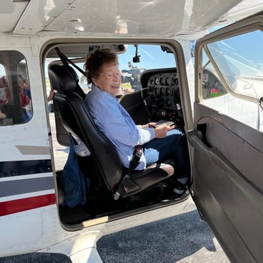 Cedarhurst resident Evelyn Kidd sits in the passenger's seat of a Cessna airplane just before taking flight over St. Louis' Gateway Arch and the Missouri River.
