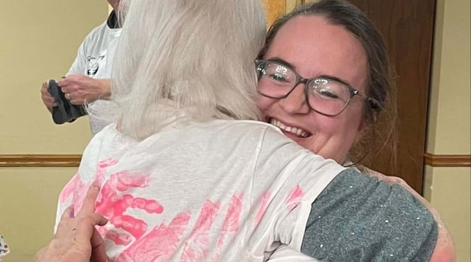 Two women smiling and hugging for the Forever Hug event at Cedarhurst senior living