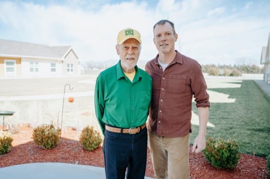 Senior living resident Dr. George poses for a photo with Rolf