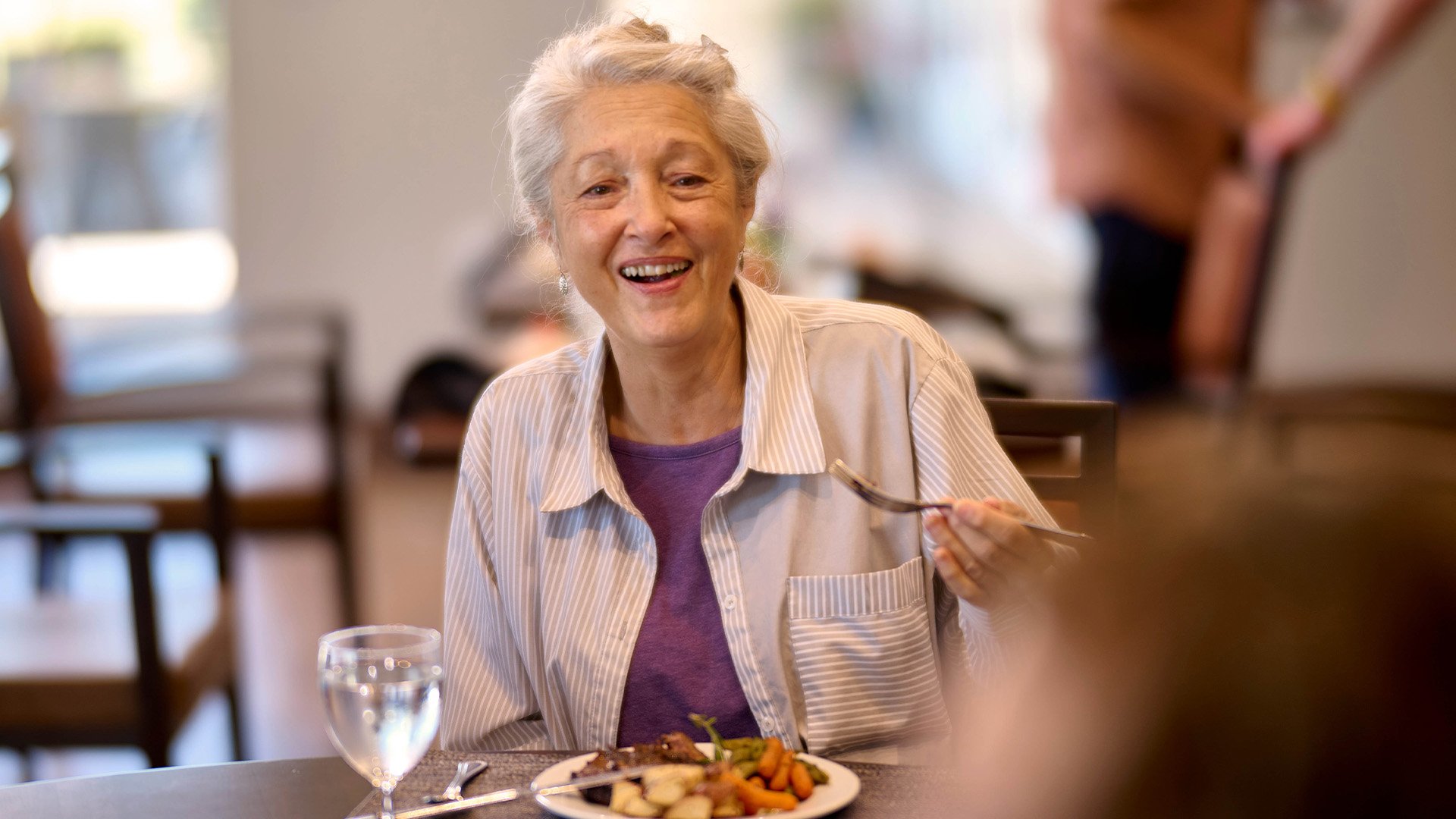 Senior woman eating lunch in the dining room