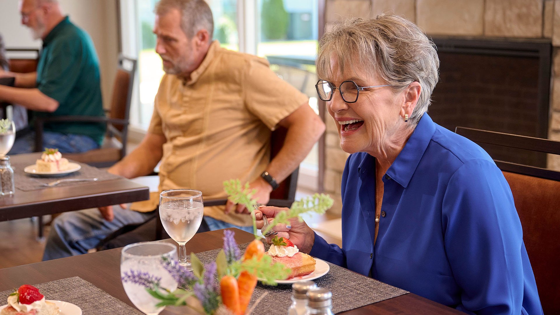 Smiling senior woman eating dessert