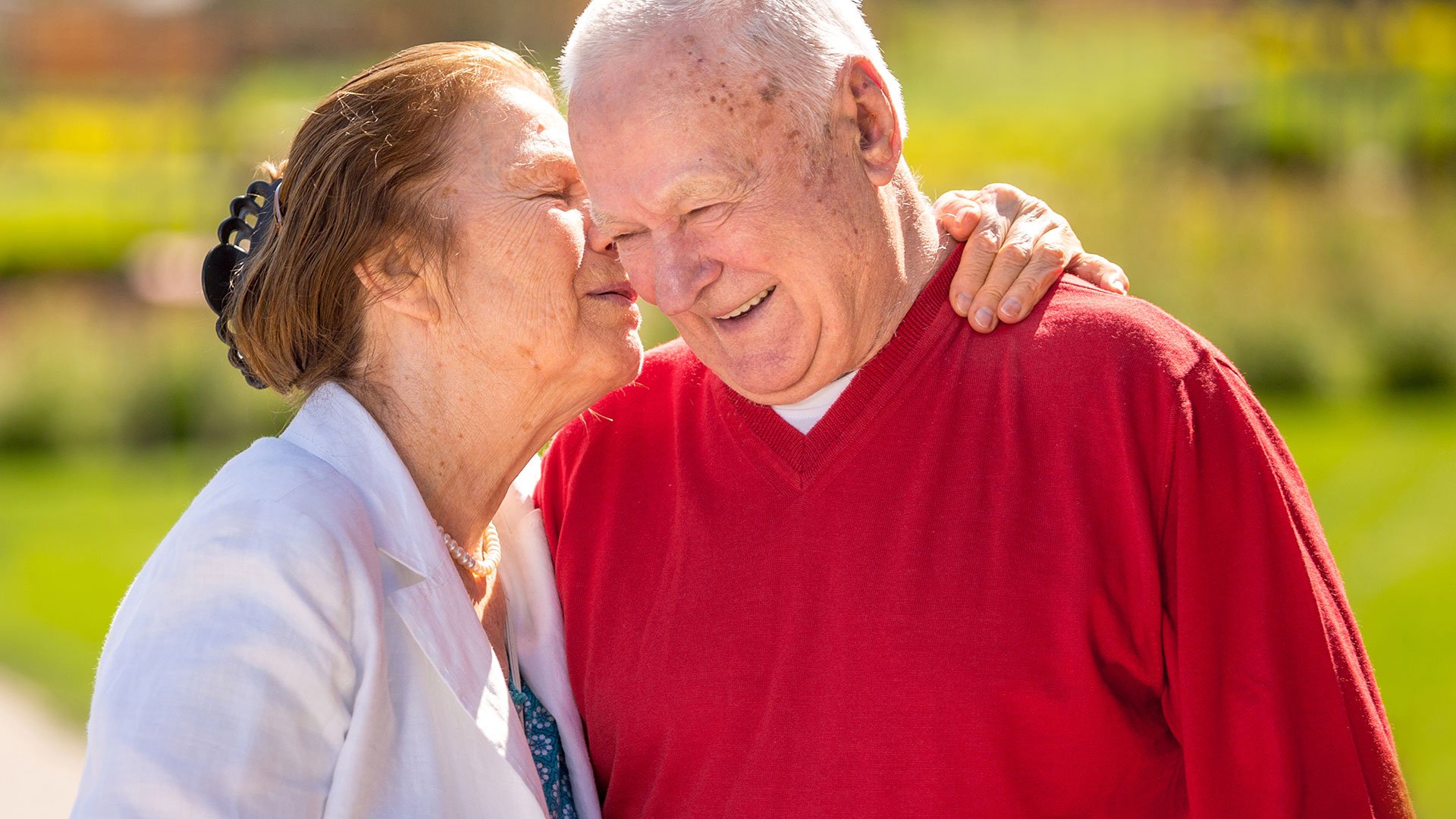 Cheerful senior couple having a good time in the city park