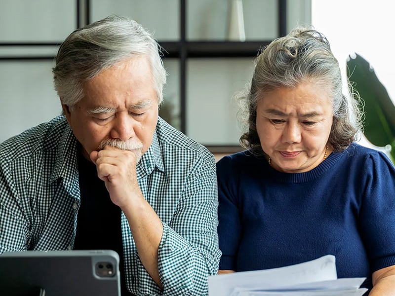 Senior living residents looking at documents