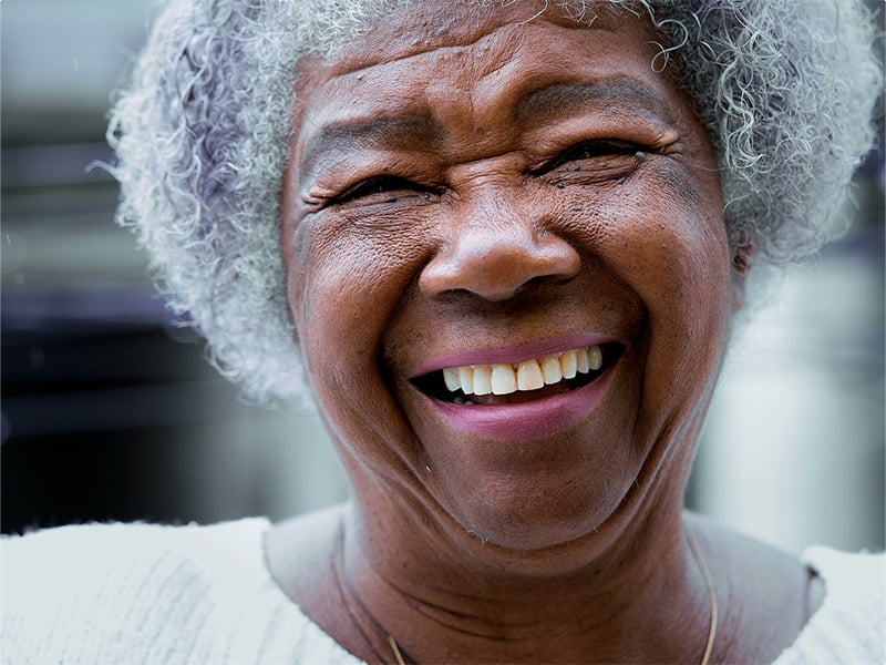 Senior living resident smiling at the camera