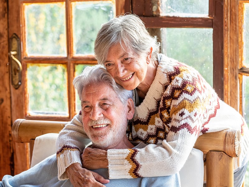 Senior living residents holding each other