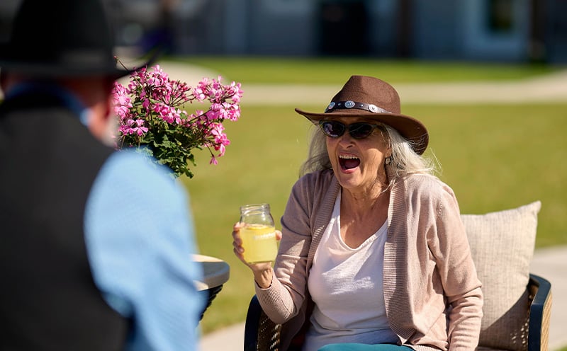 Senior living resident smiling and having fun in outdoor area