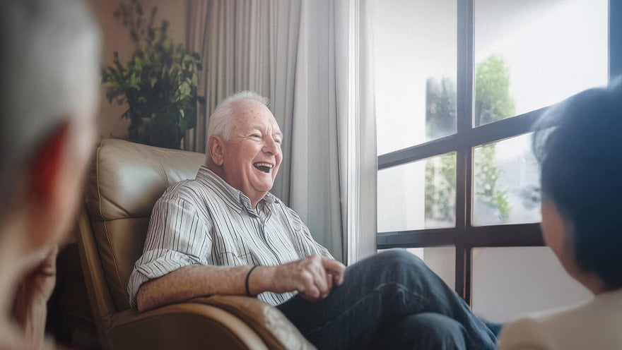 Senior living resident smiling in cozy living room