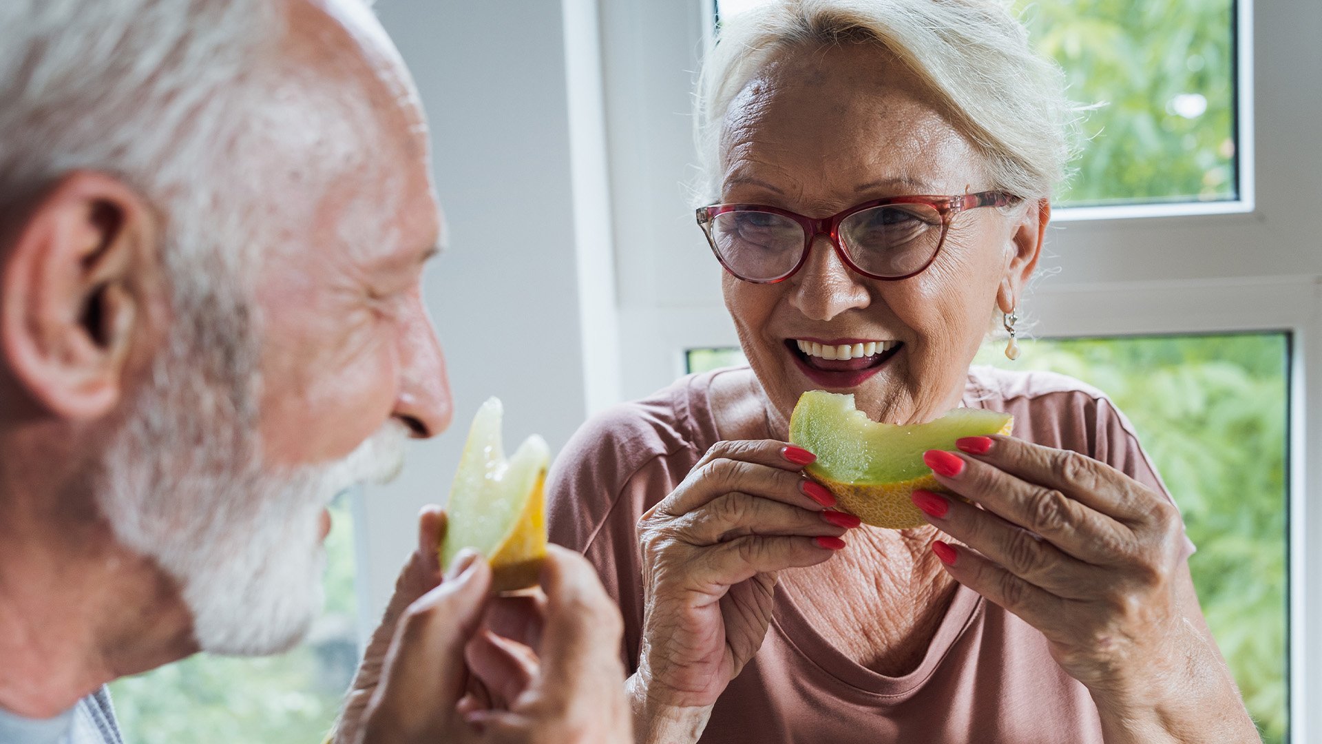 Senior man and woman eating a healthy snack