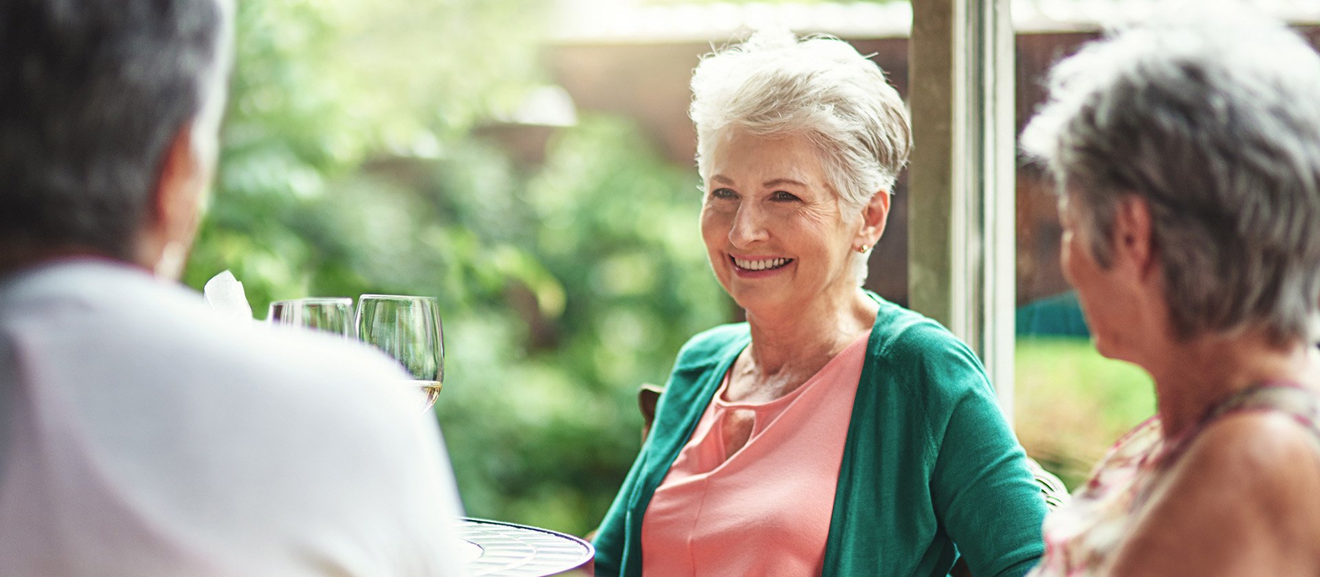 Senior woman smiling to a group of friends