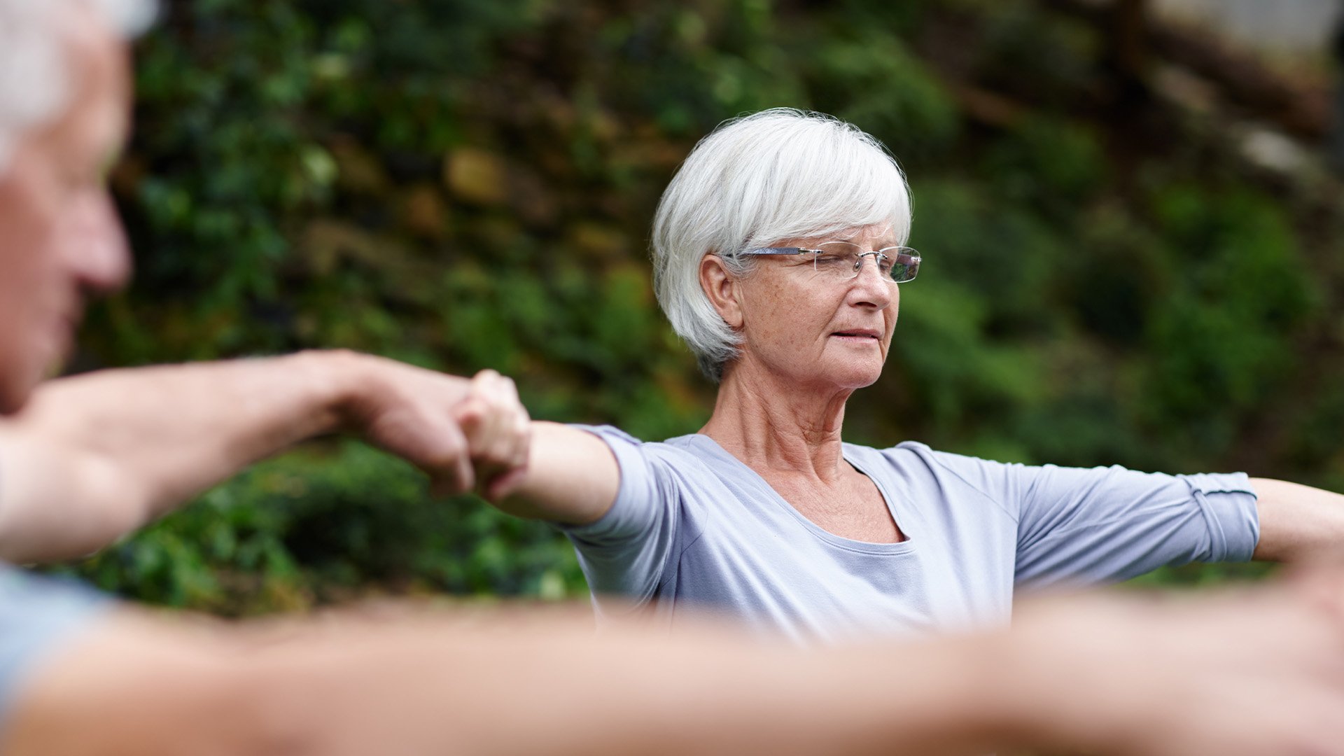 Senior woman holding hands in a circle
