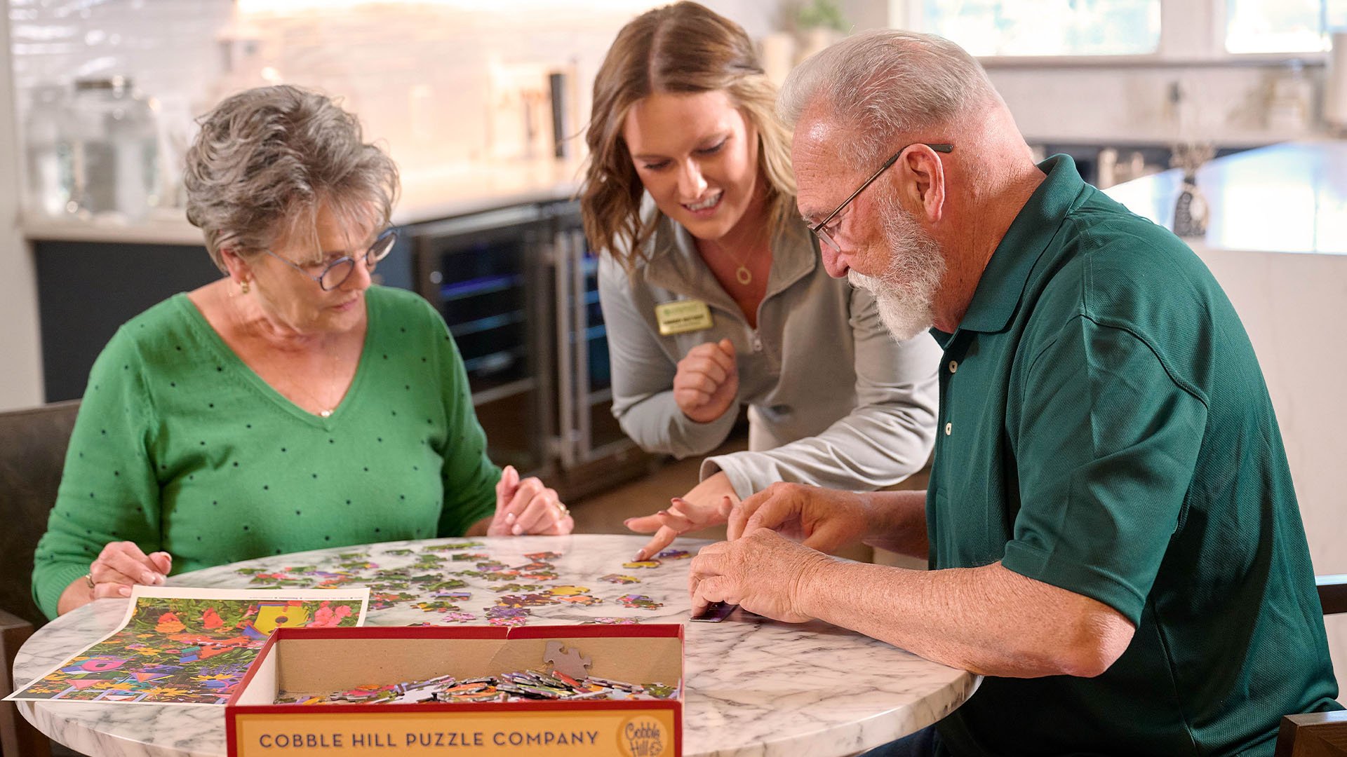 Group of seniors building a puzzle with staff member