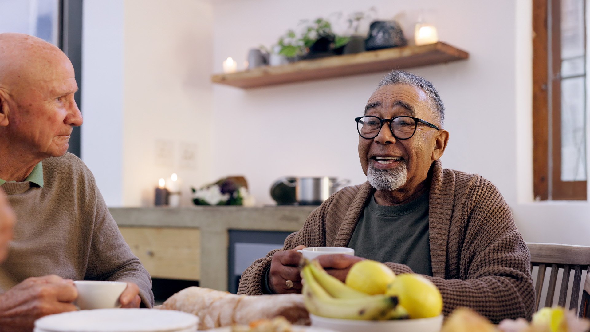 Senior men eating together