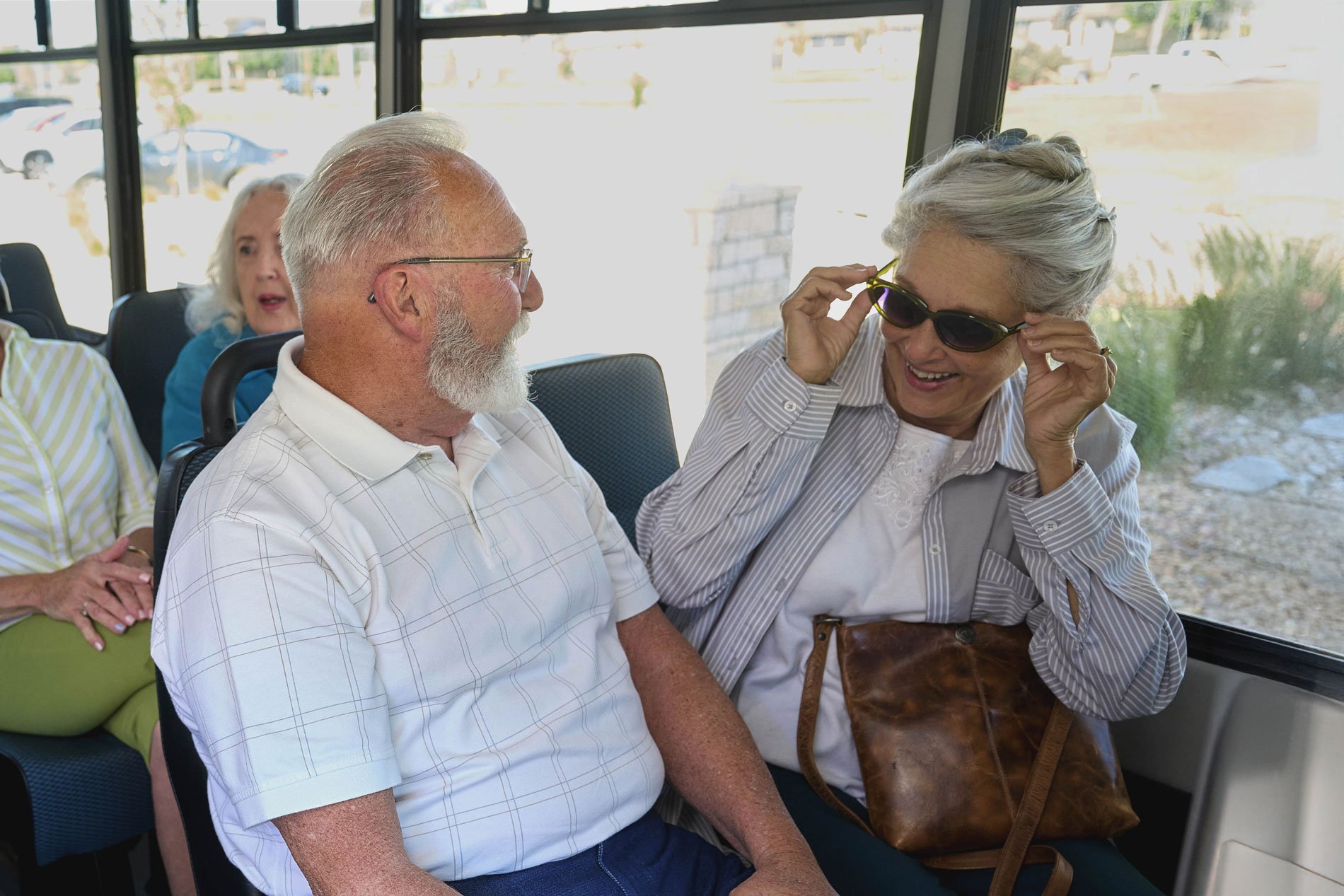 Group of seniors seating in a bus