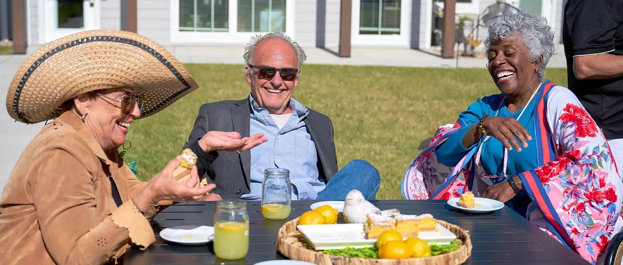 group of seniors enjoying lemonaide outsde on a sunny day