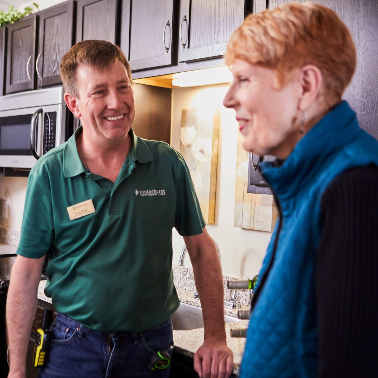 cedarhurst repairman smiling with a senior woman