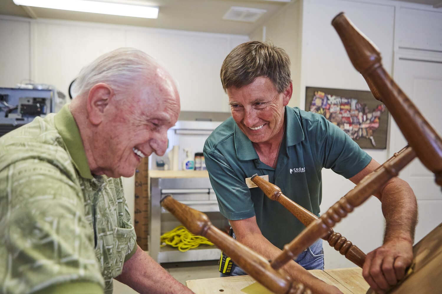 A team member and senior resident in a woodworking class