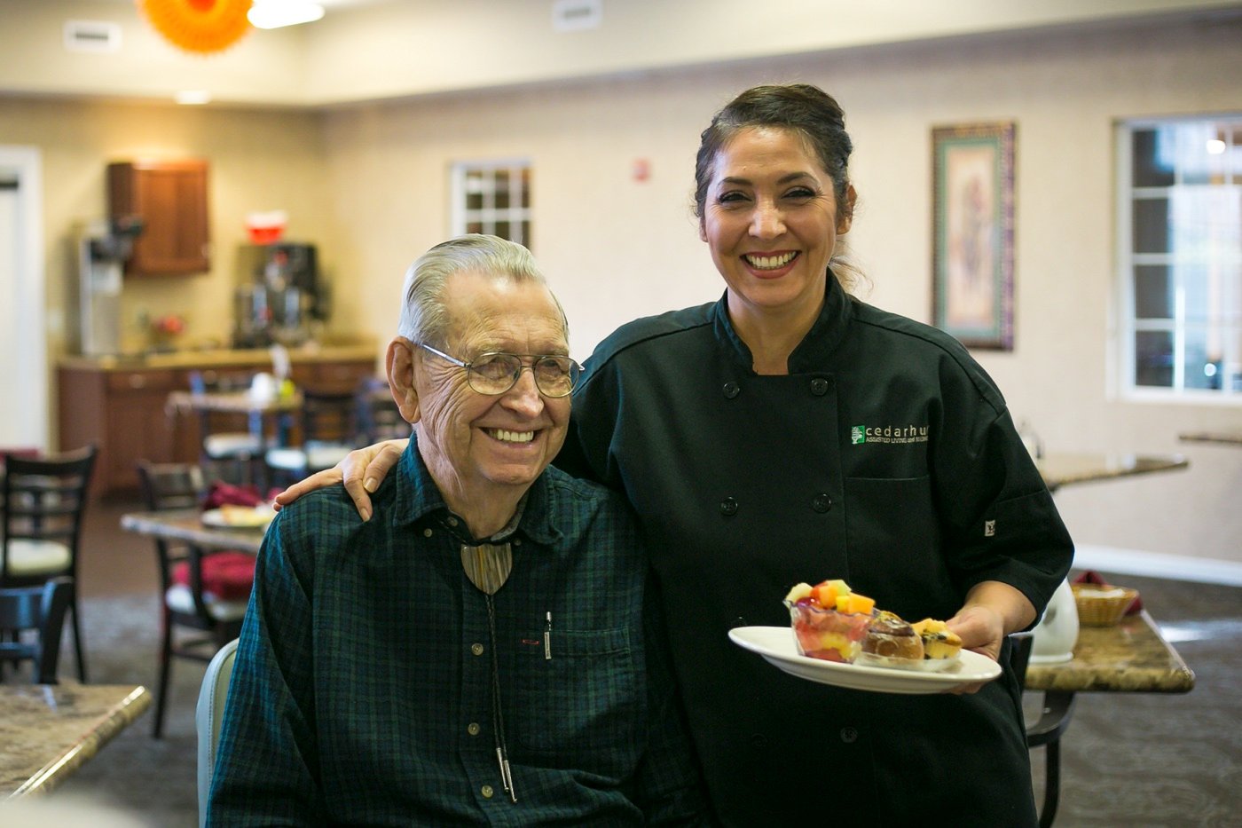 Chef With Meal taking a picture with Senior