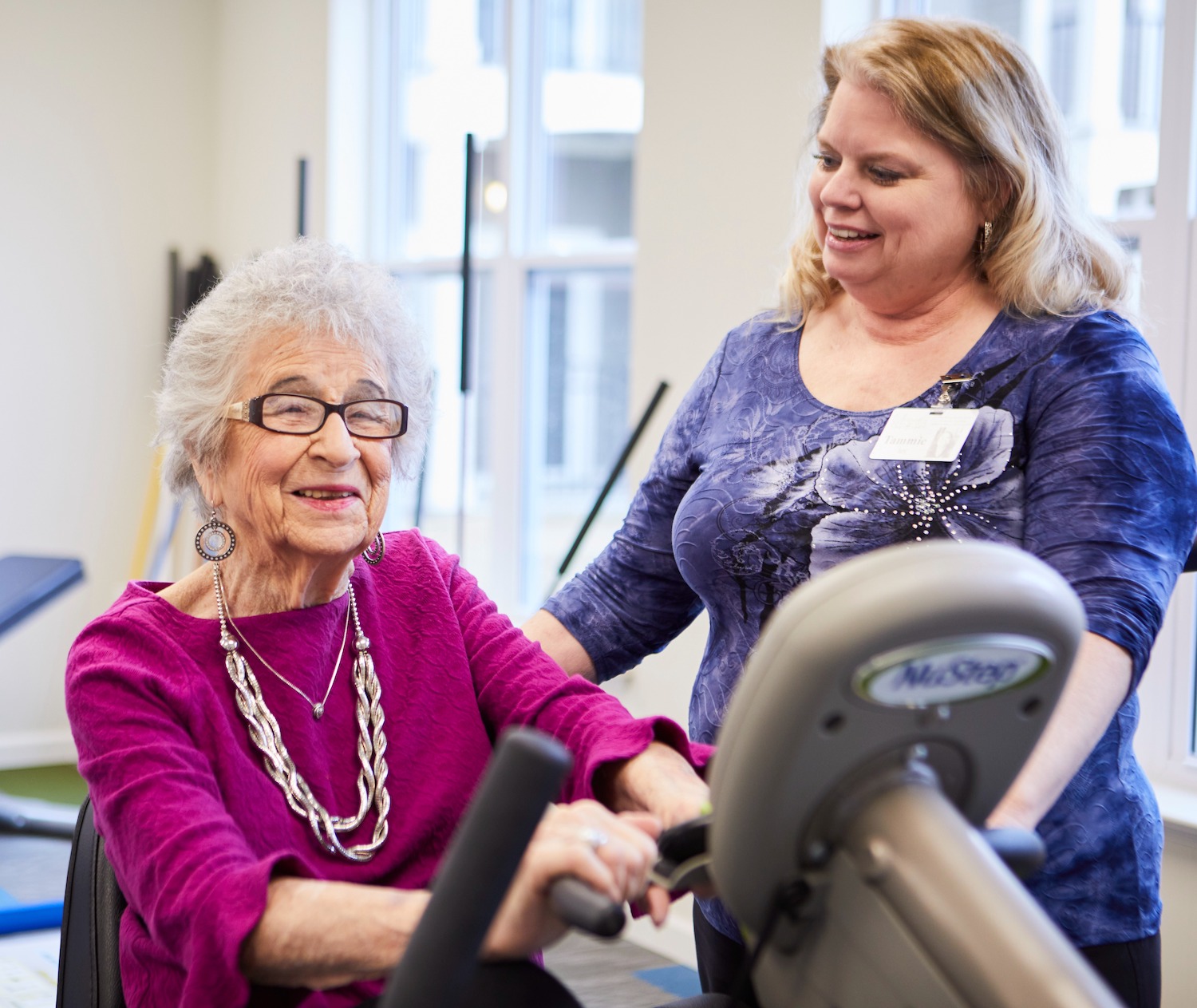A senior resident working out with the help of a team member