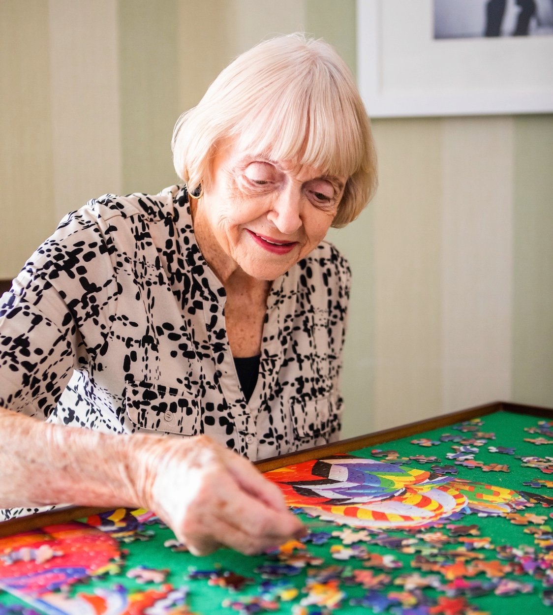 Senior woman completing a jigsaw puzzle