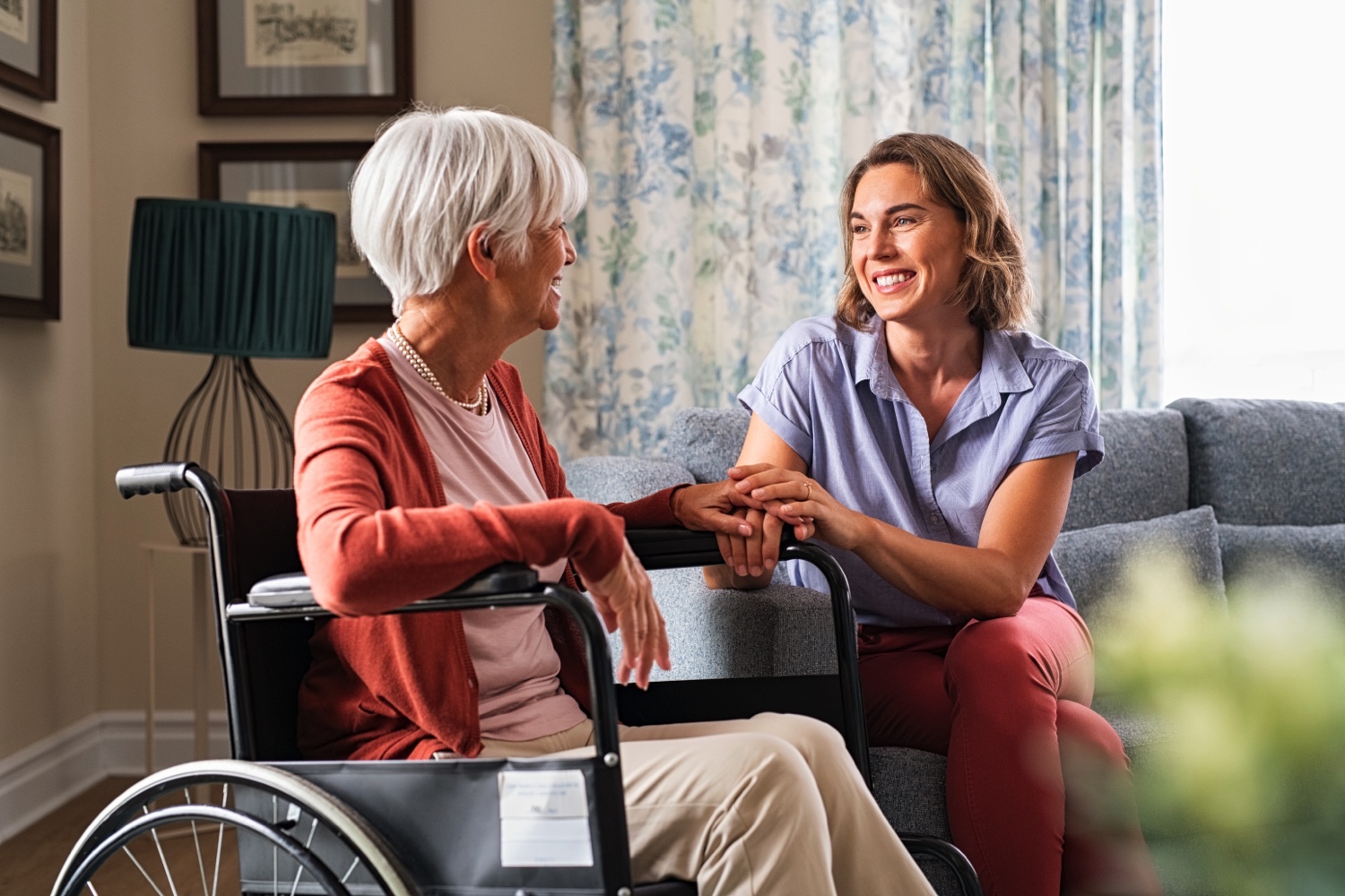 Happy adult woman visiting her elderly mother