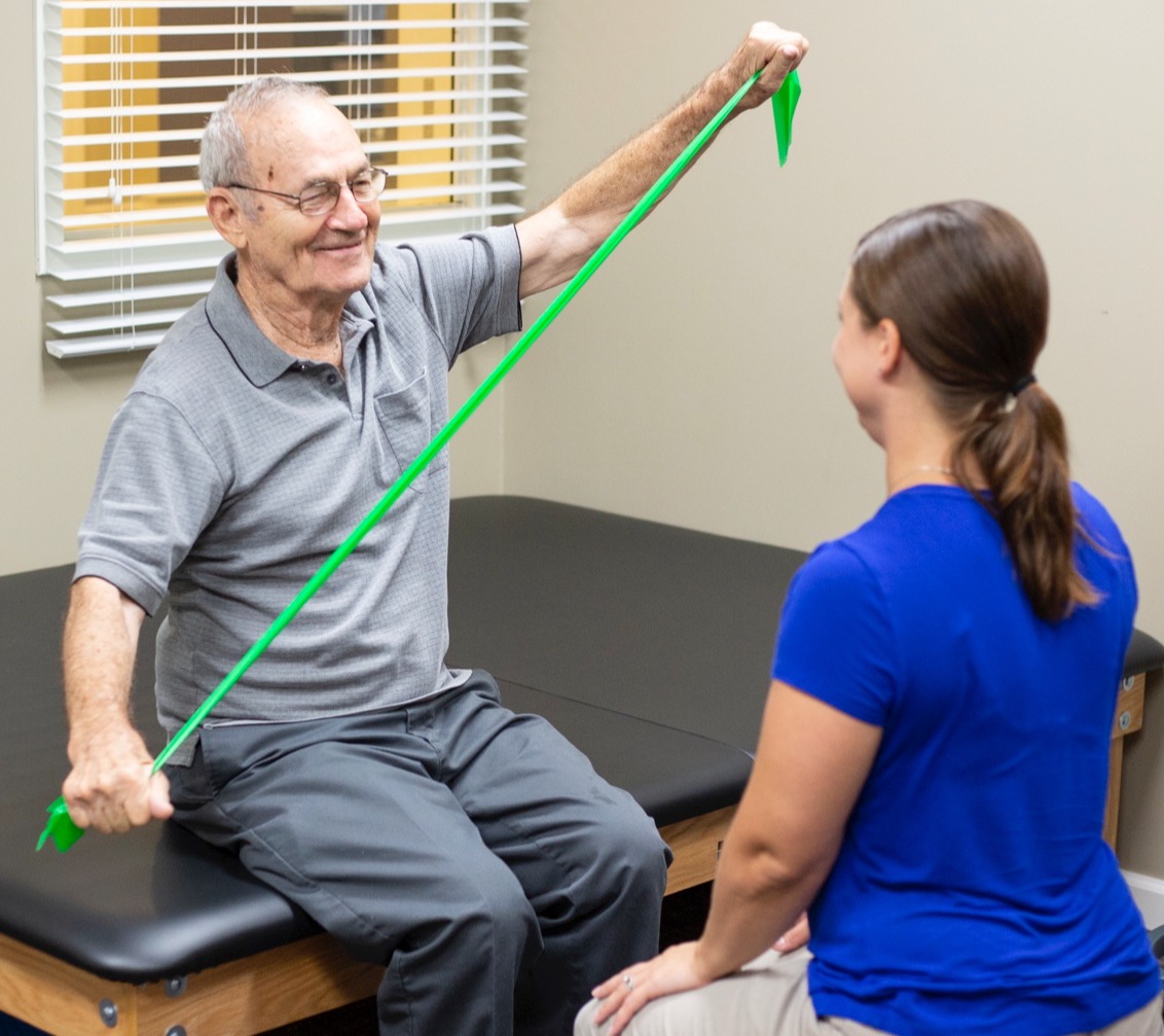 Resident in physical therapy with a medical trainer
