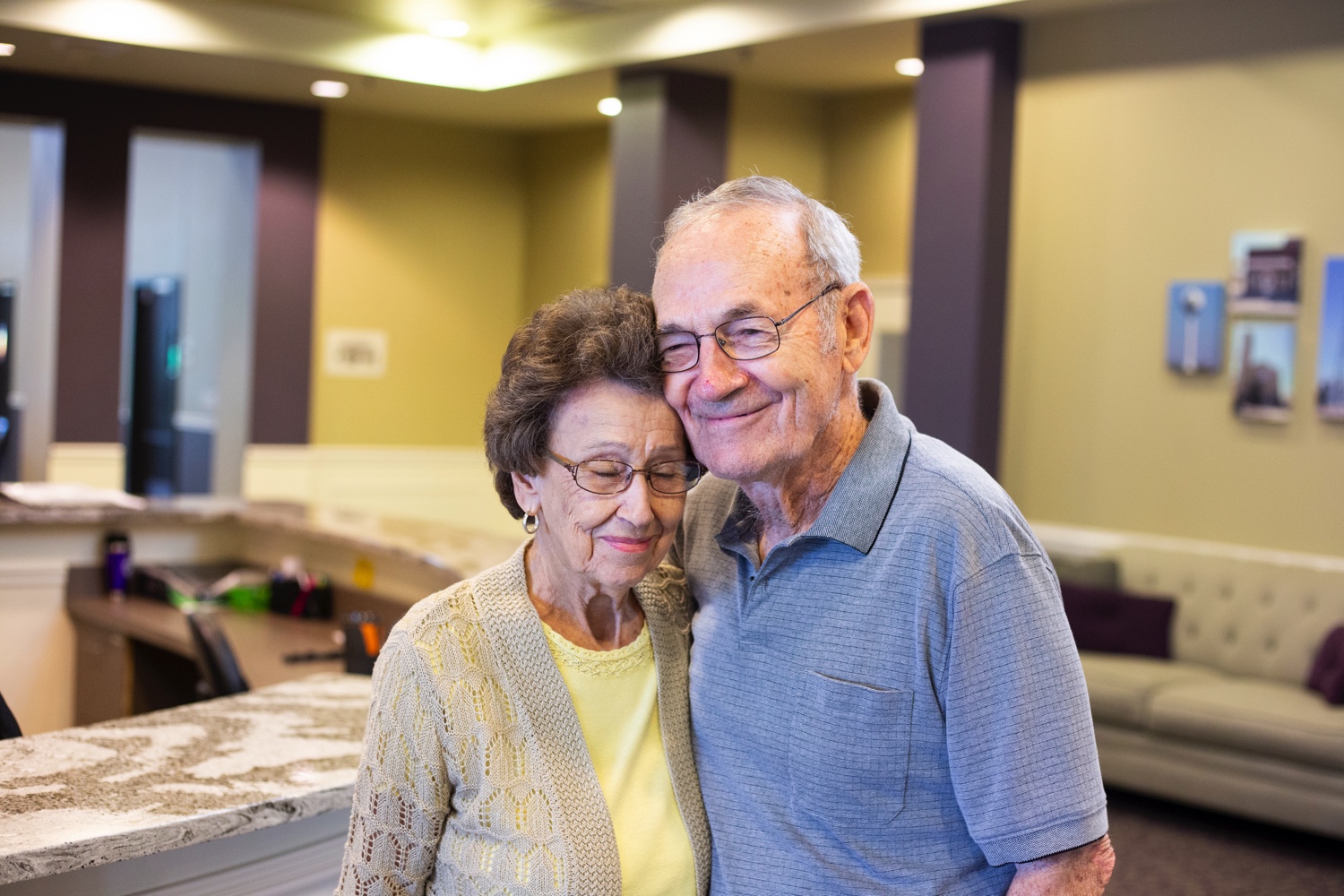 Two residents smiling together in a living room