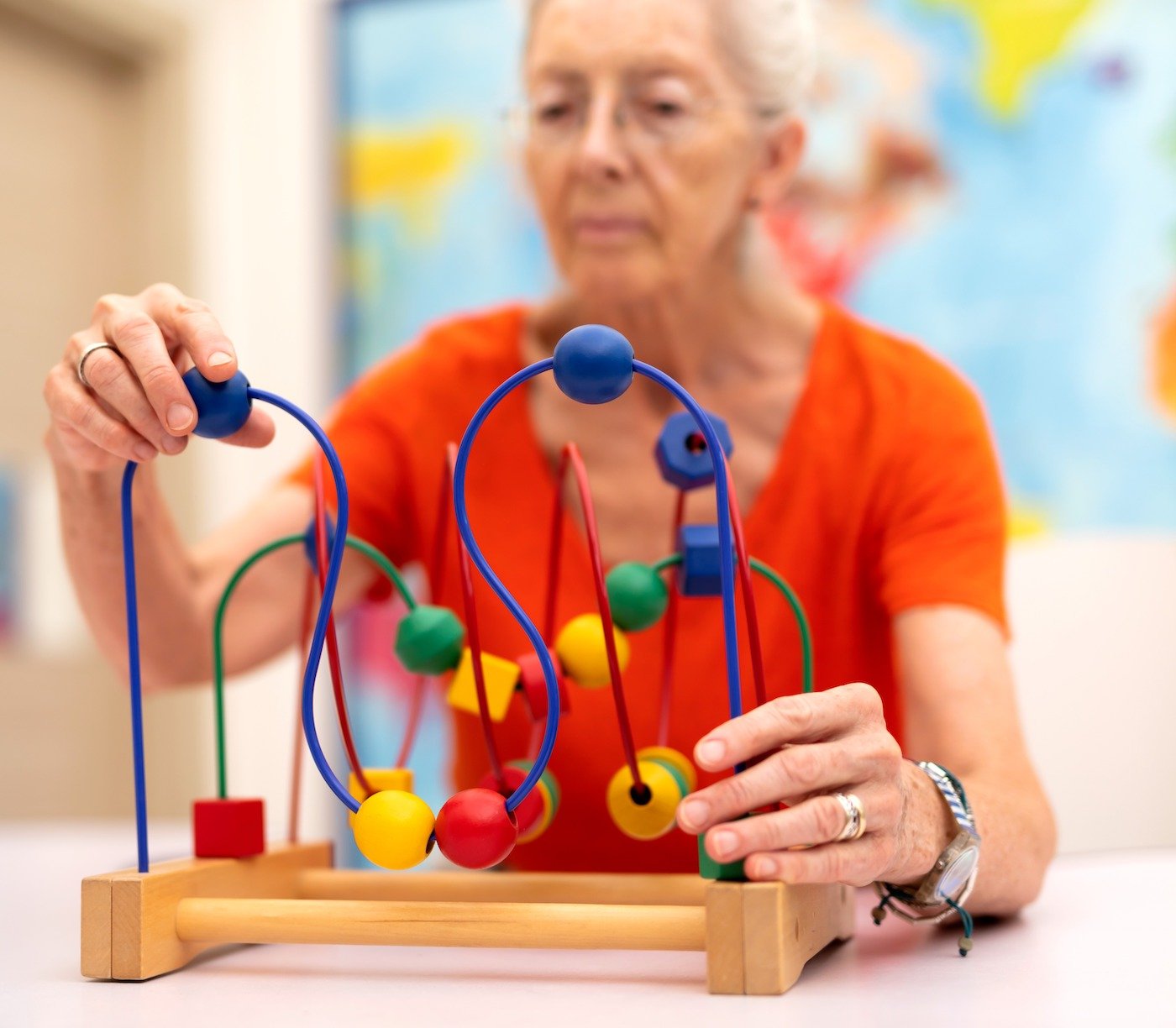 A senior woman plays with a sensory stimulating toy