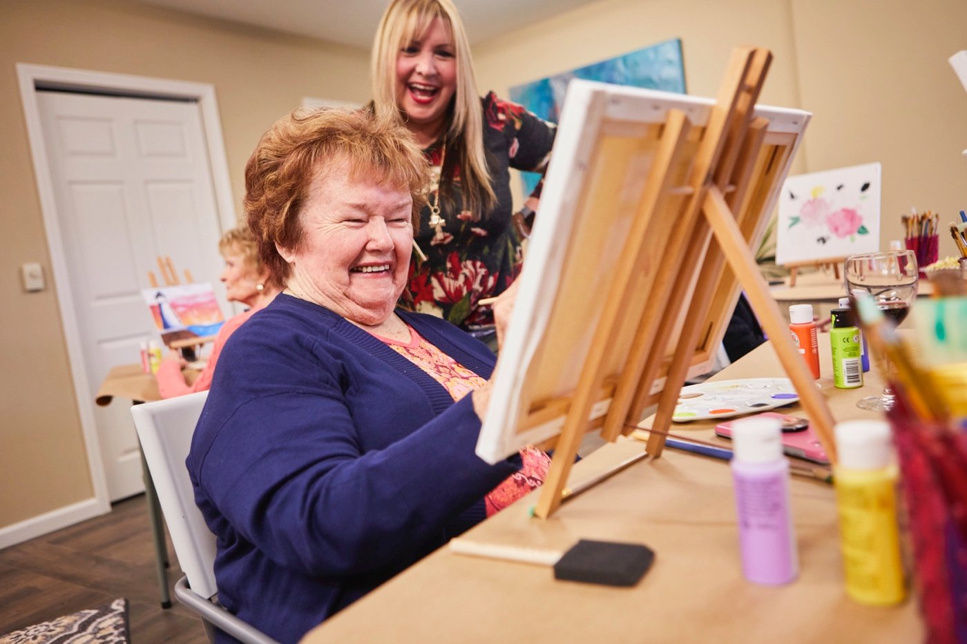 A senior woman participating in a painting class