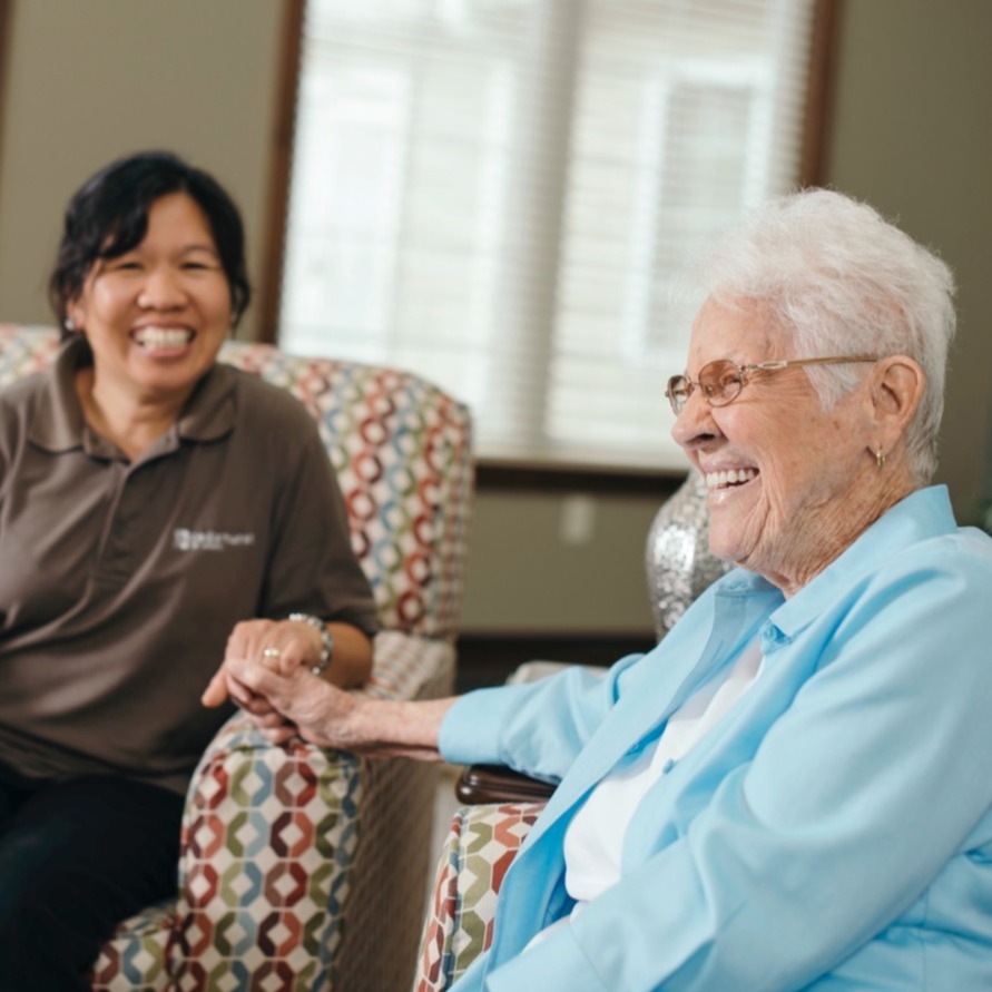 Staff member enjoying company with a senior resident