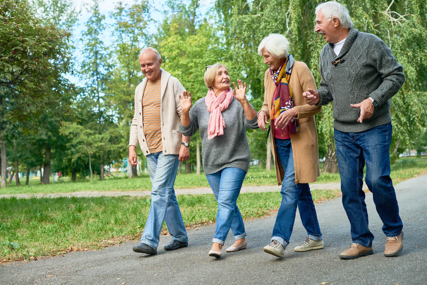 Senior friends at independent living community walking together