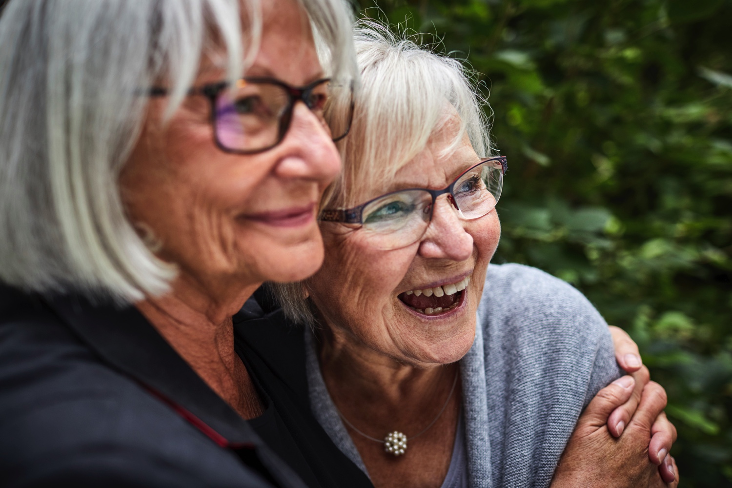 Two senior women hugging