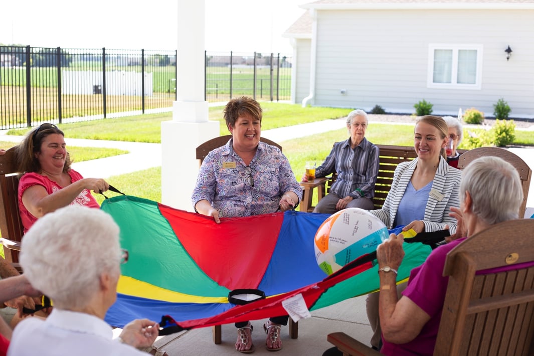 Residents sitting in a circle performing a group activity