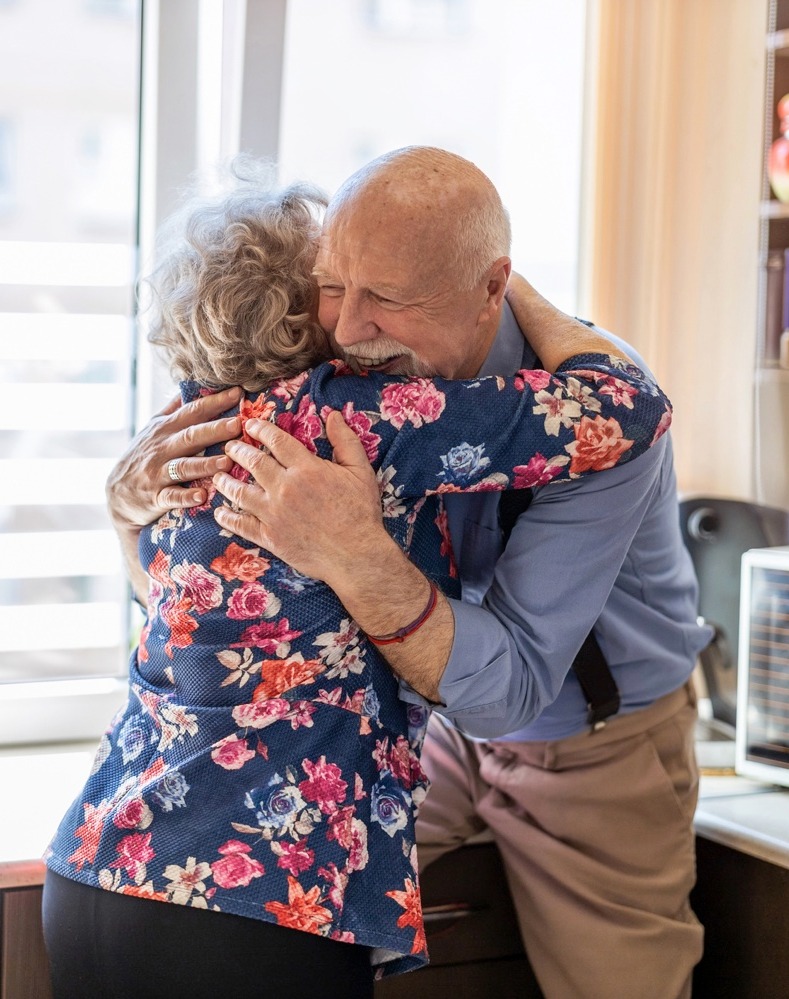 Elderly couple embracing and smiling 