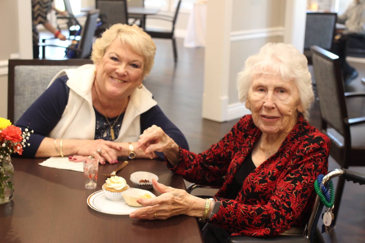 Senior women smiling during tea time in the community restaurant