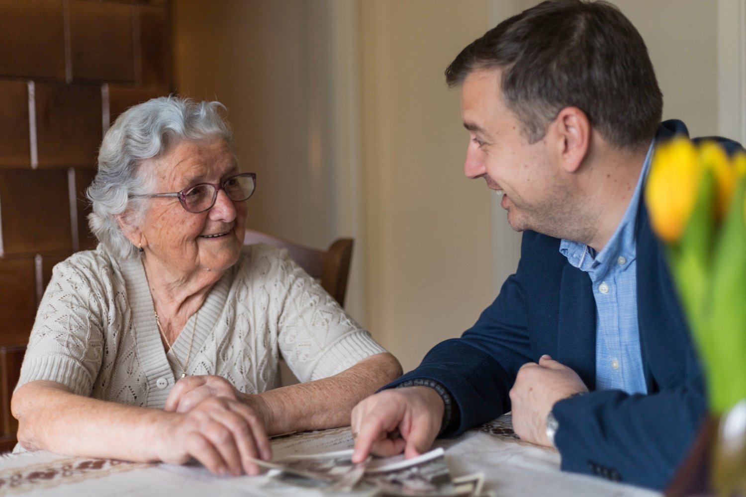 grandmother looking at old photos with grandson