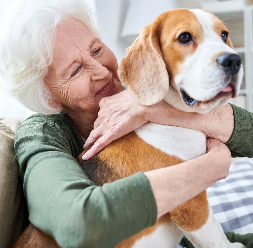 Happy senior hugging her dog