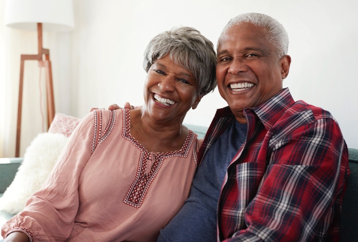 Happy senior couple relaxing on couch