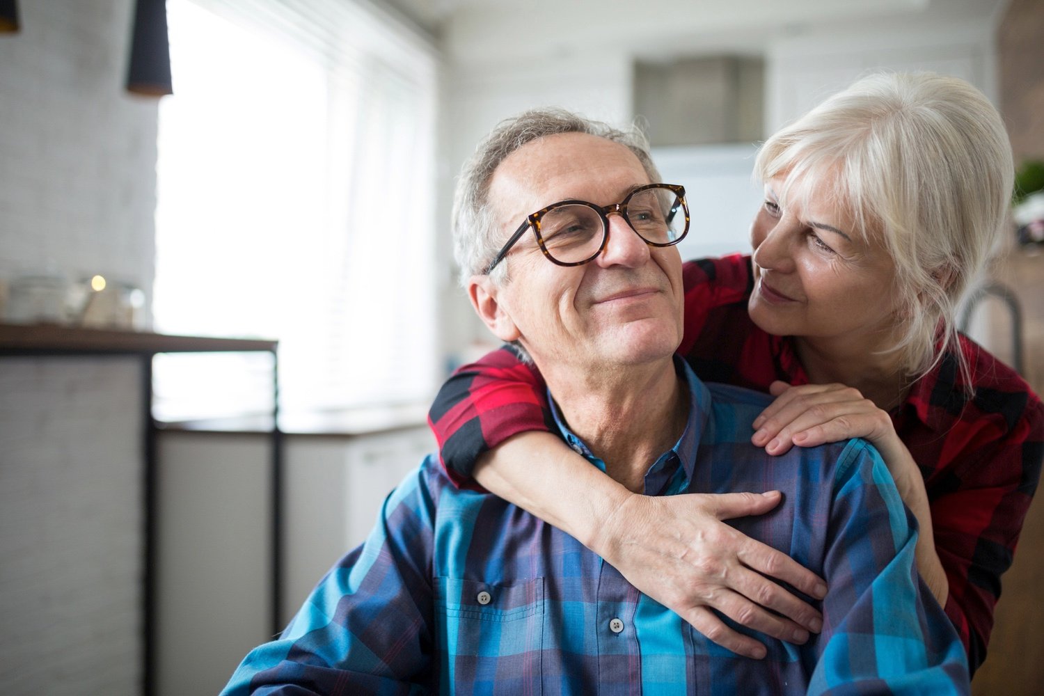 Happy senior woman embracing her husband