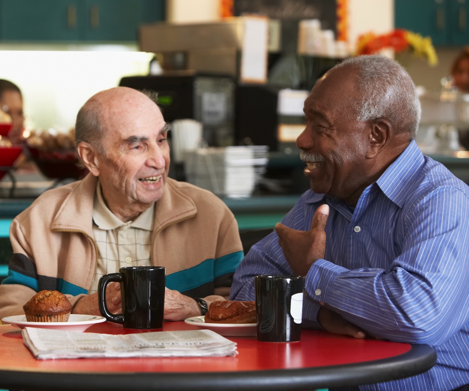 Two senior men chatting over coffee