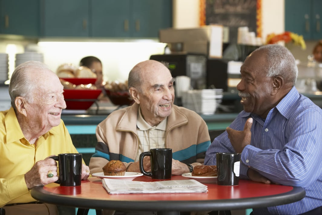 senior men drinking coffee and talking