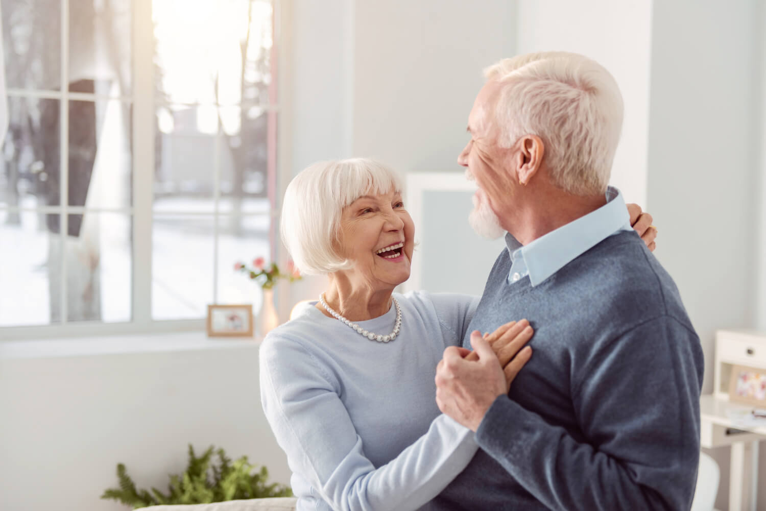 Senior couple embracing at home