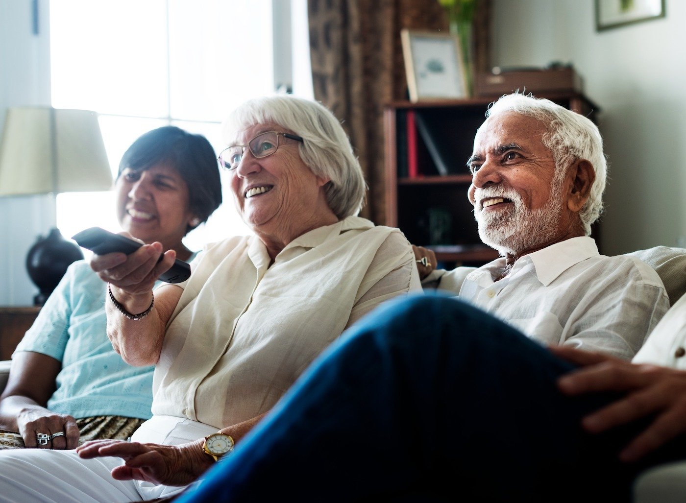 Senior friends watching tv together