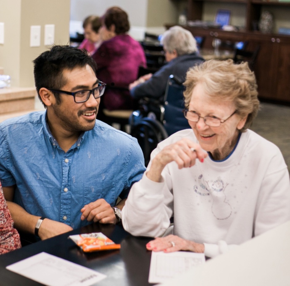 Staff member chatting with senior woman