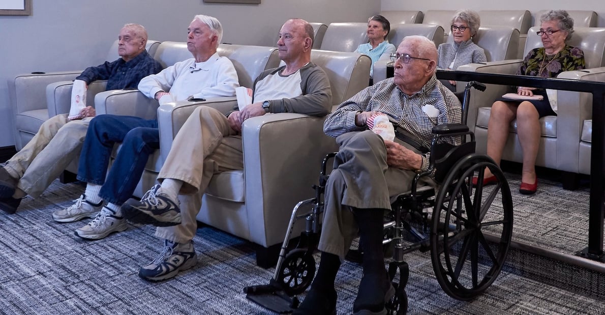 Seniors watching a film in the on-site community theater