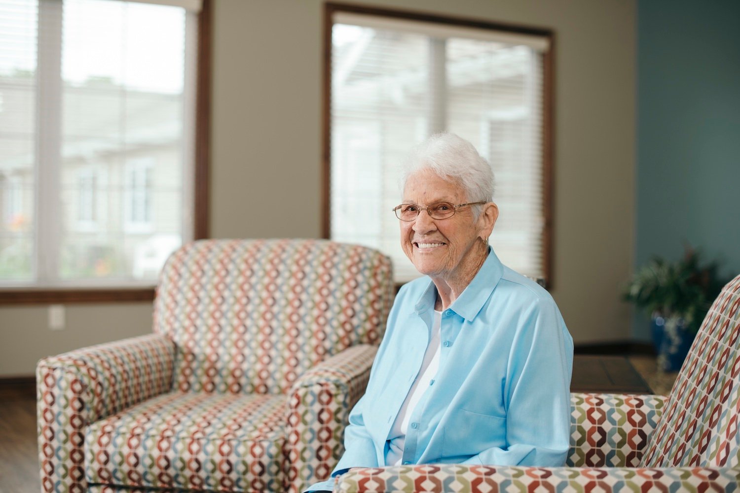 A resident smiling in a living room