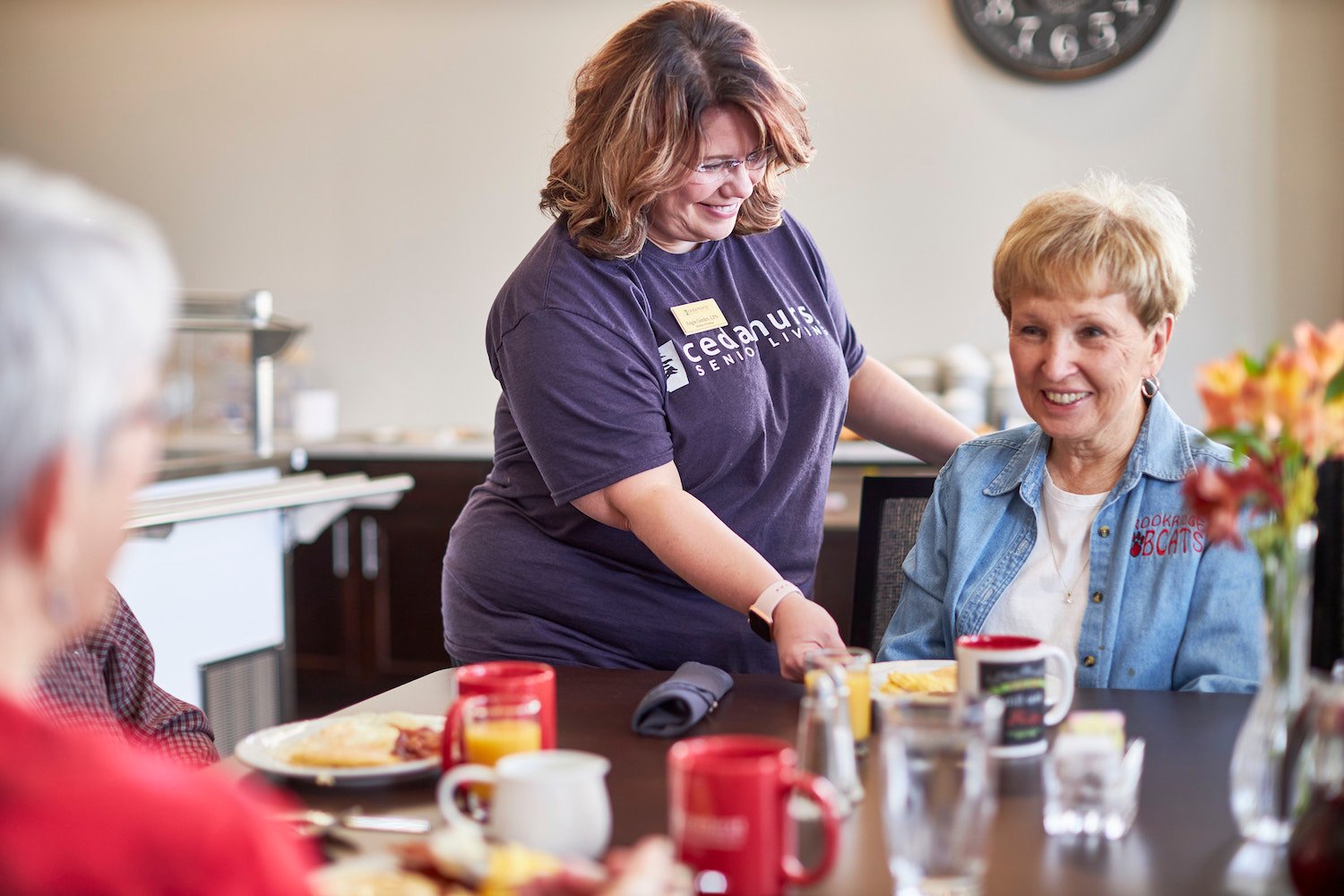 Senior friends enjoying a meal at a Cedarhurst Senior Living community