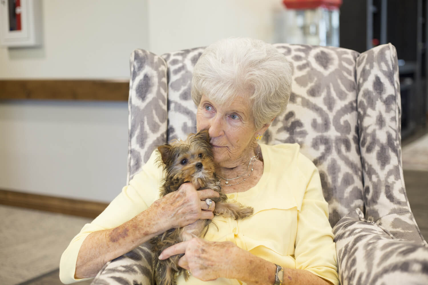 senior woman holding a small dog
